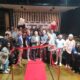 A group of people at an indoor ribbon cutting ceremony for Ride Lounge