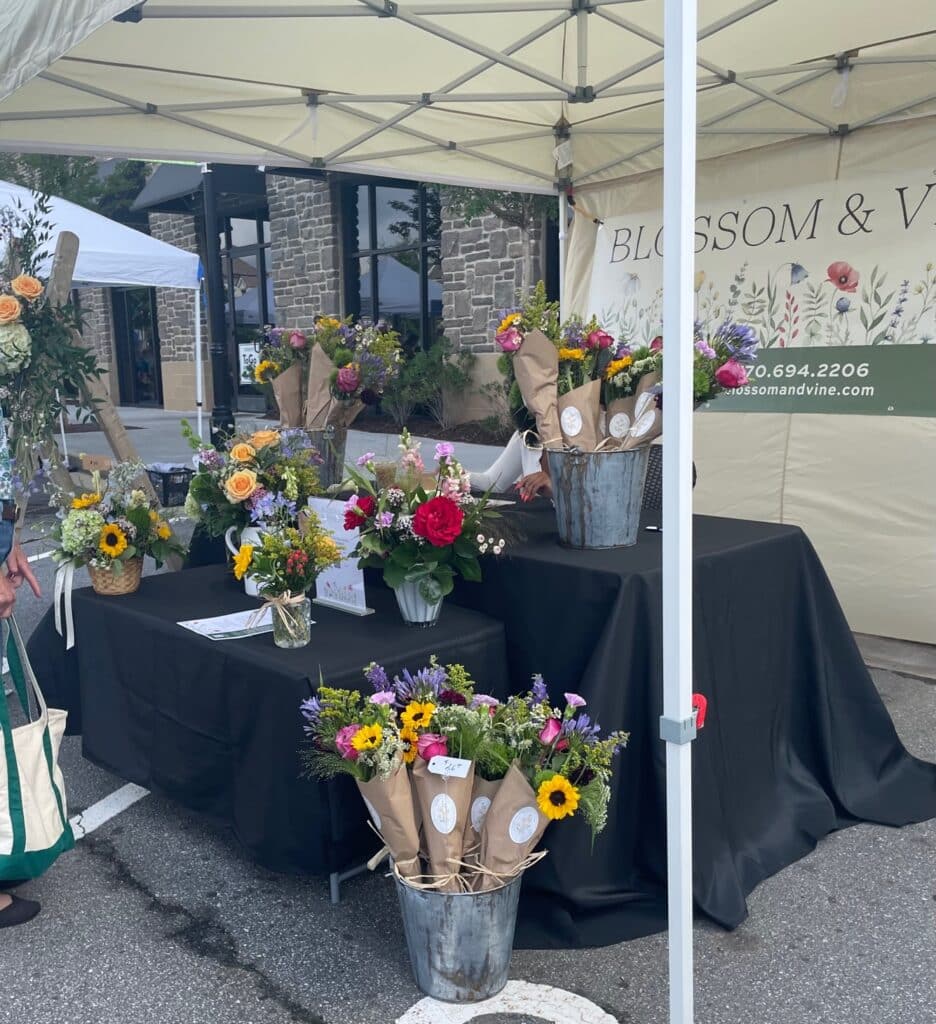 A booth of cut flower arrangements from Blossom & Vine