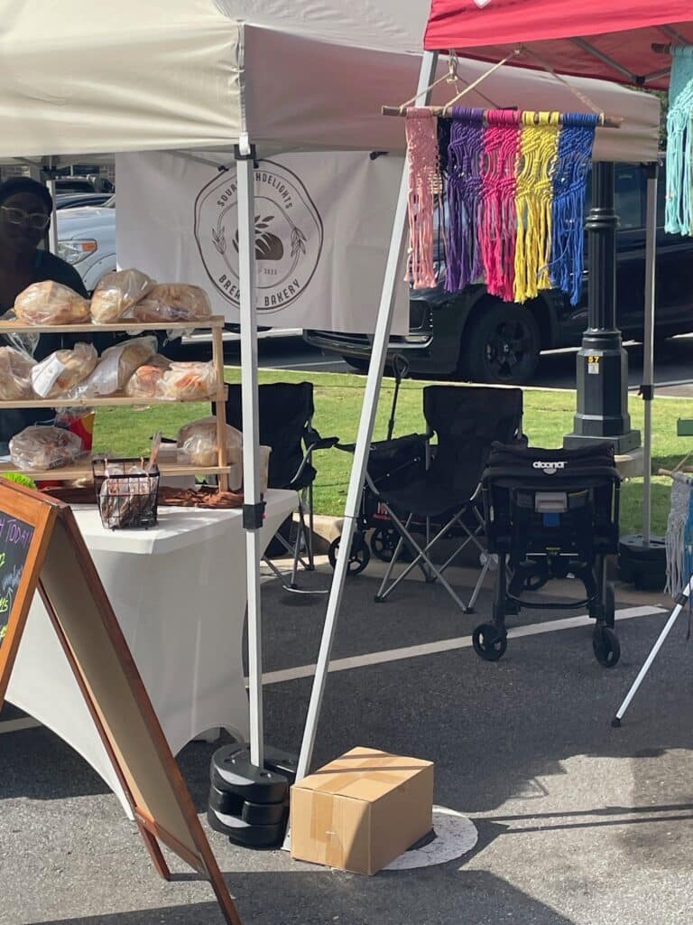 Sourdough bread and handcrafted goods at an outdoor farmers market