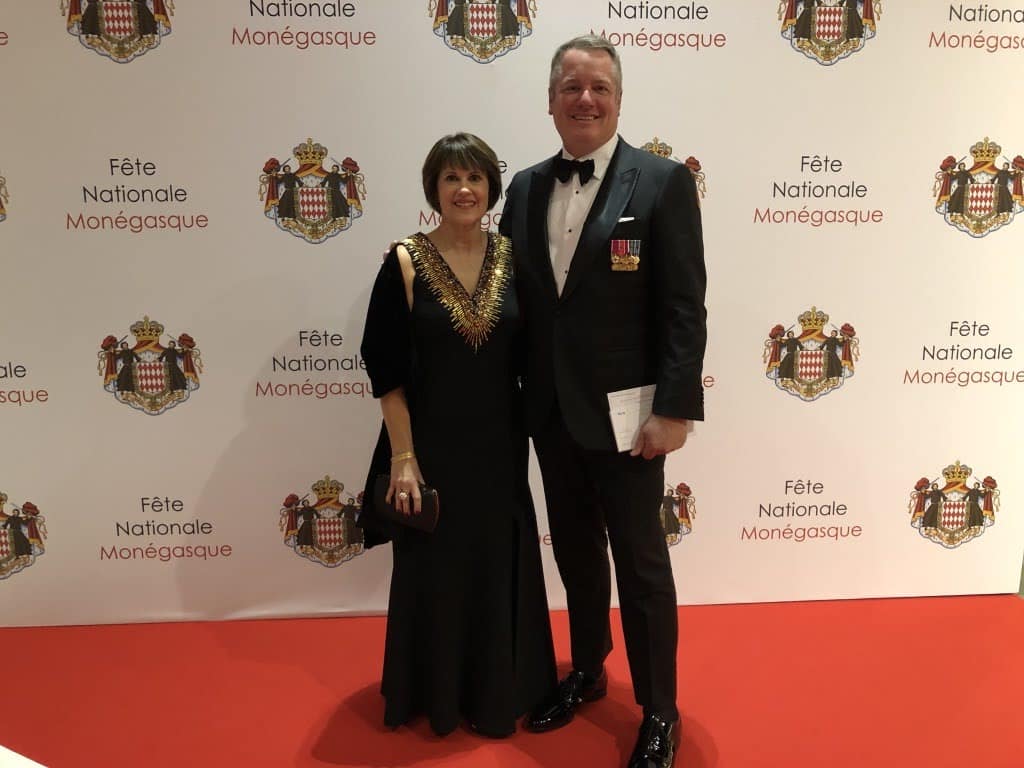 A man and woman dressed up on a red carpet at La Fete Nationale in Monaco.