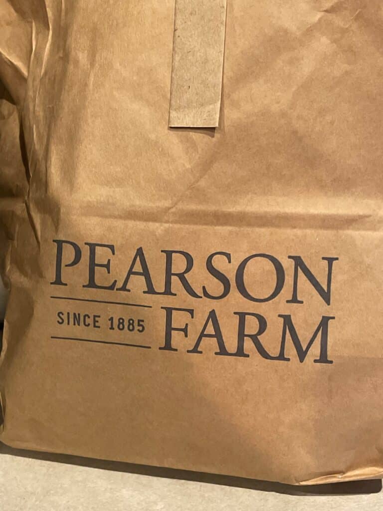 A brown paper bag with the Pearson Farm logo