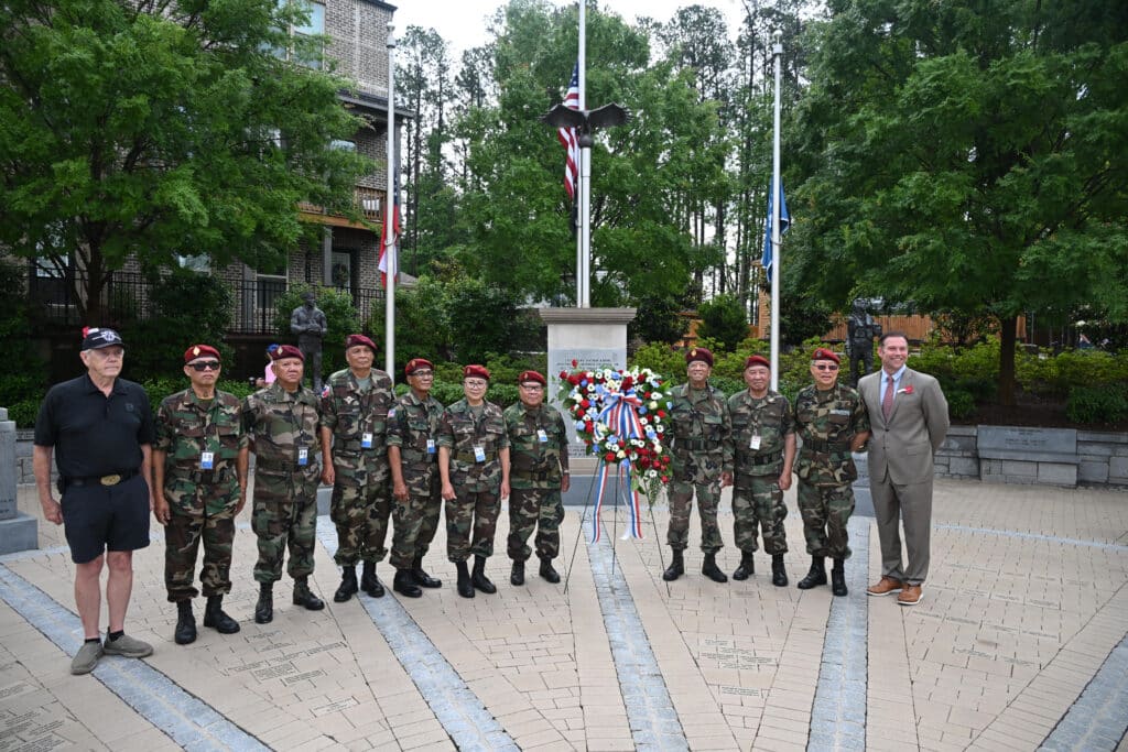 Veterans and city officials in front of a veterans' monument on memorial day 2025