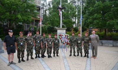 Veterans and city officials in front of a veterans' monument on memorial day 2025