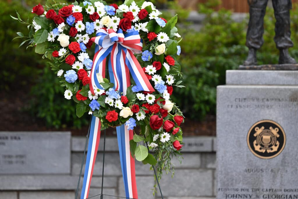 A wreath in front of a veterans' memorial